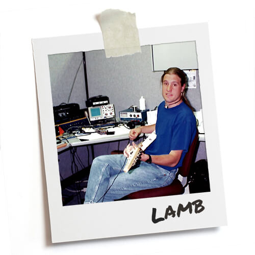 Polaroid photo of Jason Lamb reclining with a guitar in a DigiTech office